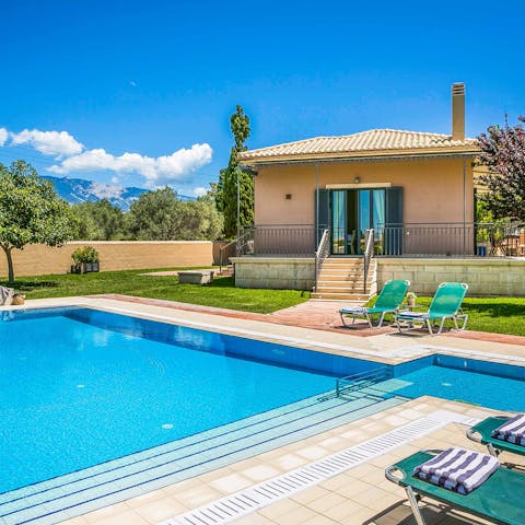 Soak in the sun around the villa's private pool