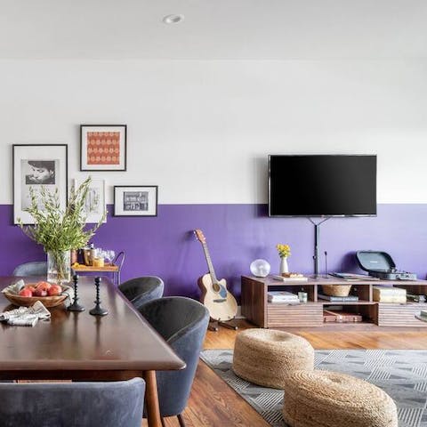 Play a few chords on the guitar and watch TV in the living room