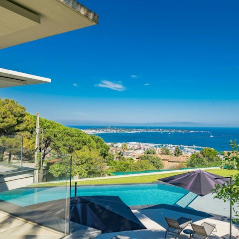 Take in the stunning sea view from the heated infinity mirror pool