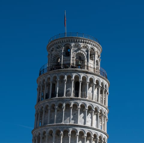 Spend an afternoon exploring Pisa, a thirty-five-minute drive away