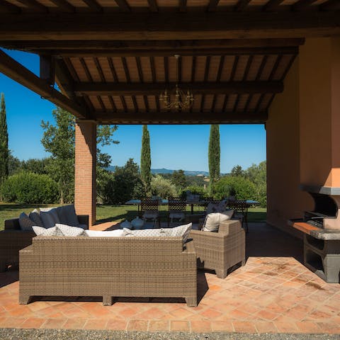 Lounge on the shaded terrace with your favourite book and a glass of local wine