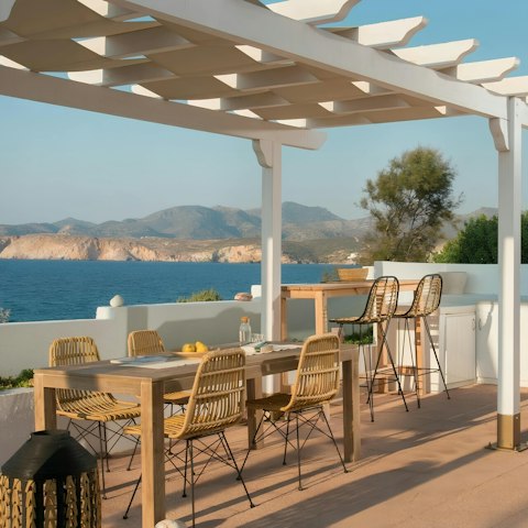 Enjoy an alfresco drink on the shared terrace overlooking the Aegean Sea