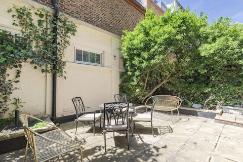 Step out to the garden and gather around the mosaic table for cocktails