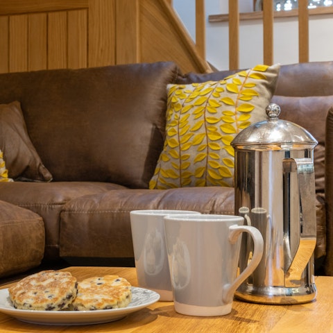 Tuck into your host's welcome pack – savour Welsh cakes on the L-shaped sofa
