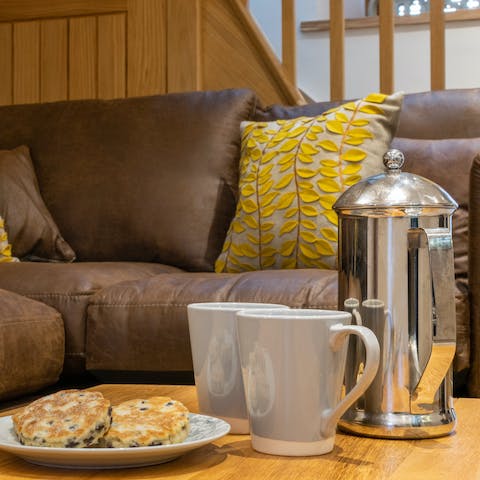 Tuck into your host's welcome pack – savour Welsh cakes on the L-shaped sofa