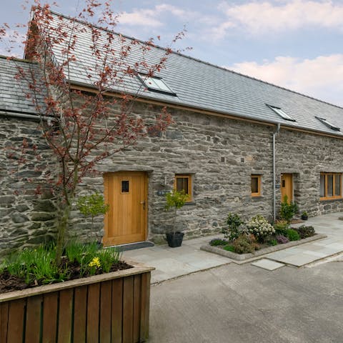 Admire the rustic exterior of this former farmhouse that you can call home