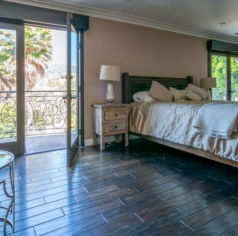 A pool-view balcony off the bedroom
