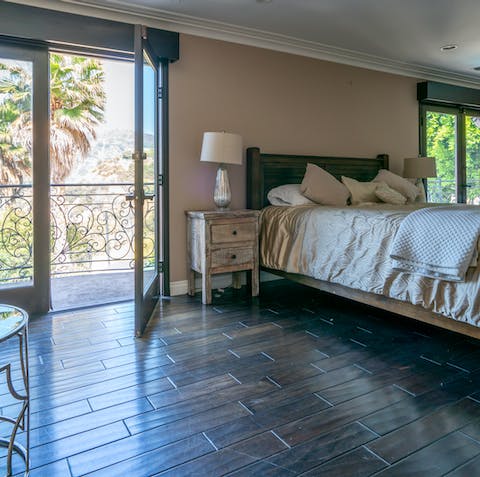 A pool-view balcony off the bedroom