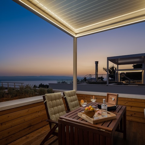 Toast the sunset with drinks on the balcony