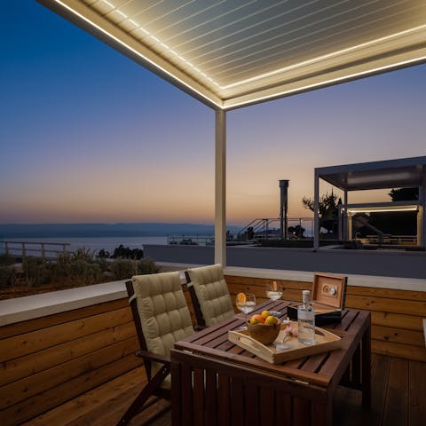 Toast the sunset with drinks on the balcony