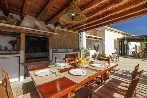 Fire up the barbecue and dine under a rustic timber canopy