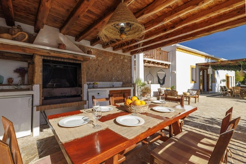 Fire up the barbecue and dine under a rustic timber canopy