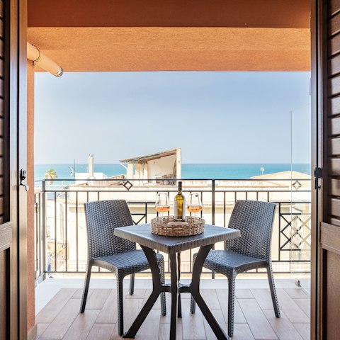 Toast the sunset from the private balcony