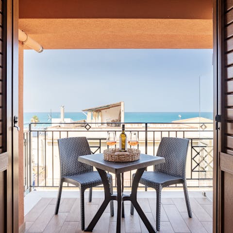 Toast the sunset from the private balcony