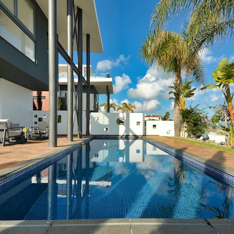 Take a swim in the pool under the clear blue sky