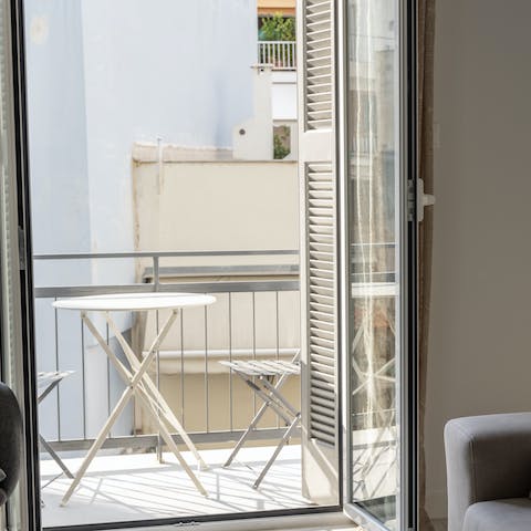 Enjoy a glass of Greek wine on the private balcony