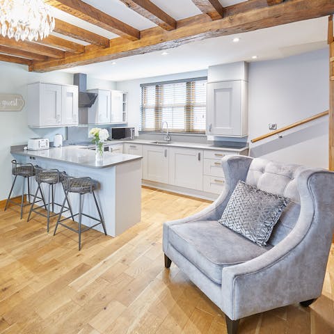 Tuck into a tasty fried breakfast as you sit on barstools beneath these wood beams