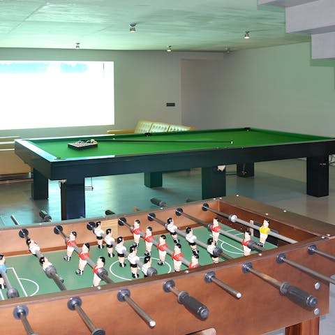 Get competitive in the games room featuring table football and pool