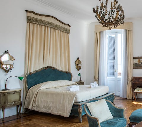 The spacious master bed and chandelier
