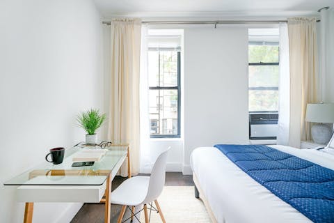 Catch up on work emails at the desk in the bedroom