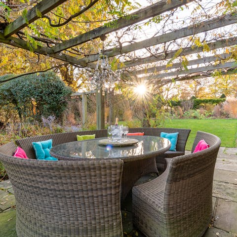 Catch the last hour of sun out on the patio underneath the pergola