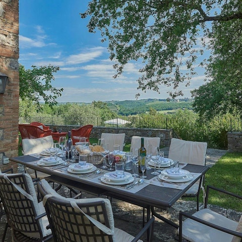 Dine alfresco with views across the Tuscan countryside