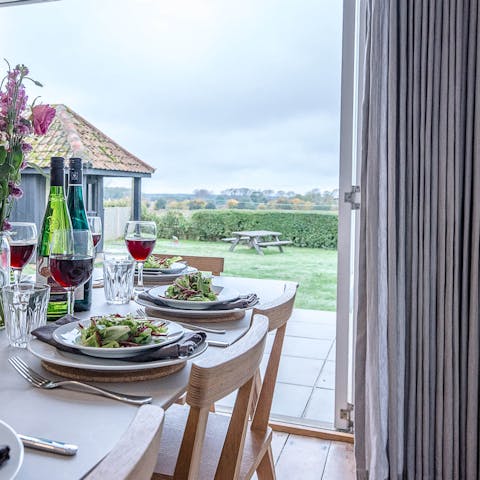 Come together for dinner in the lovely kitchen and dining area, where you'll still have that view over the surrounding landscape