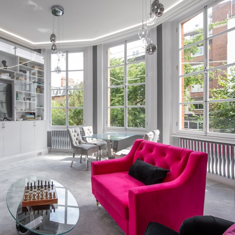 Chill out with a game of chess in the living room while taking in leafy gardens views from the bay windows