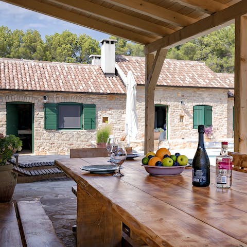 Serve up a delicious home-cooked meal under the shady pergola