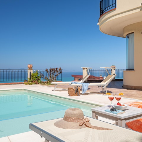 Stretch out on the scenic sunloungers after a swim