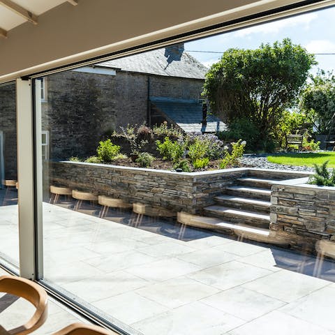 Step out for a breath of fresh air onto this lovely raised lawn area