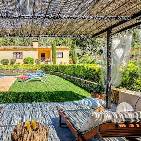 Grab and book and enjoy the shade of the pergola