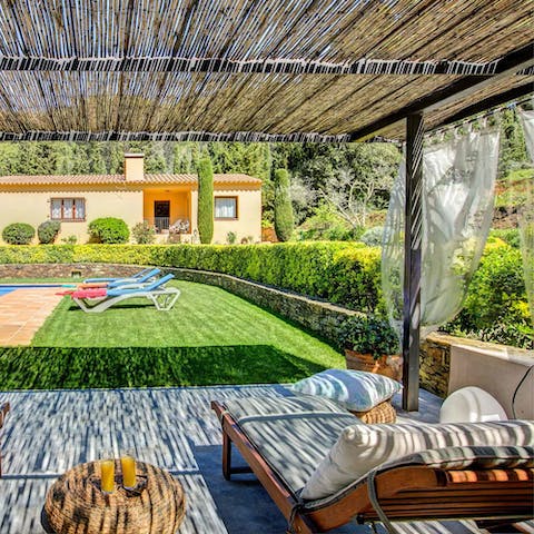 Grab and book and enjoy the shade of the pergola
