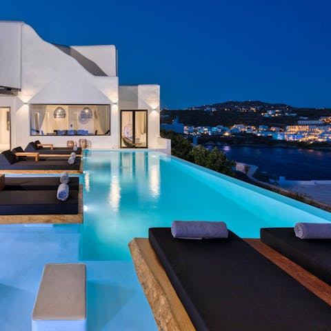 Take an evening swim overlooking the sea and sparkling lights