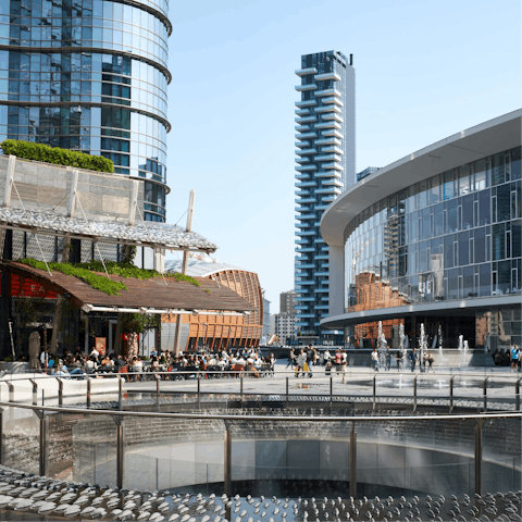 Explore the skyscrapers and shops around Piazza Gae Aulenti, a ten-minute walk away