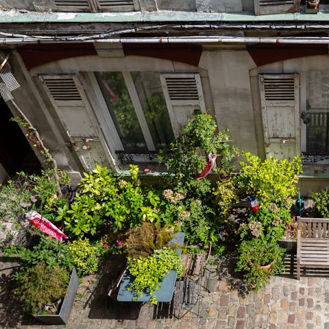 Admire beautiful views of the lush, cobbled courtyard below