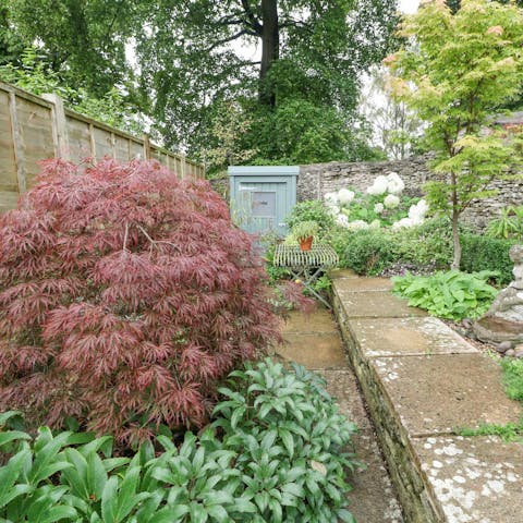 Enjoy sunny afternoons in the plant-filled patio garden