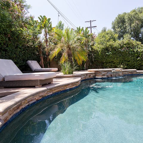 Relax around the glistening pool on the plush lounge chairs