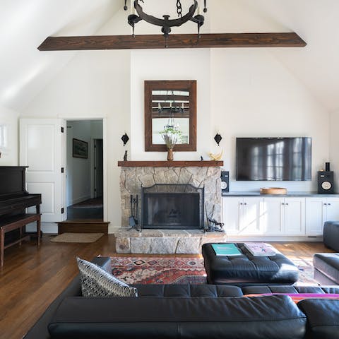 Unwind in the characterful living room with beamed ceilings and an iron chandelier