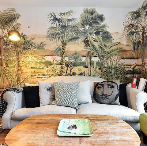 Relax in the beautifully wallpapered living area with a glass of bubbly after a day of exploring the city