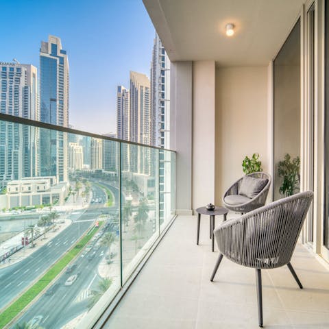 Drink in the city skyline from the private balcony