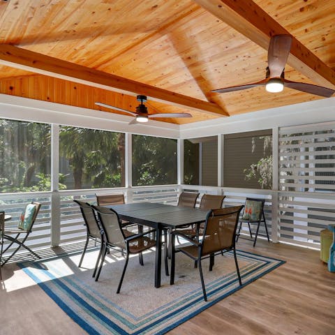 Gather for drinks and games on the screened porch