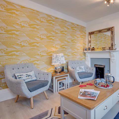 Kick back in the colourful maritime-themed living room with a glass of wine and a good book