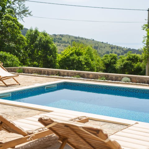 Swim laps in the pool as you gaze over the green hills