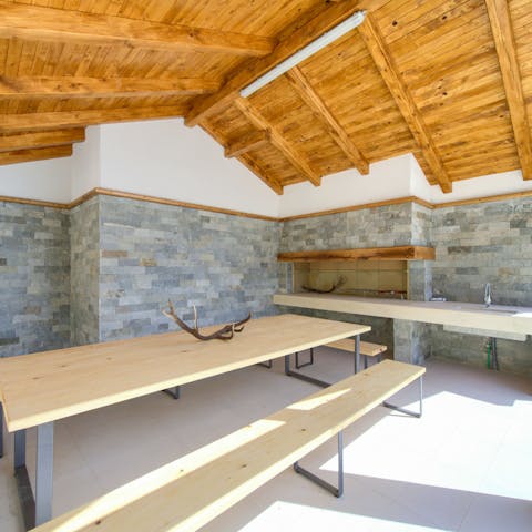 Host a rustic feast for the family in the covered outdoor kitchen