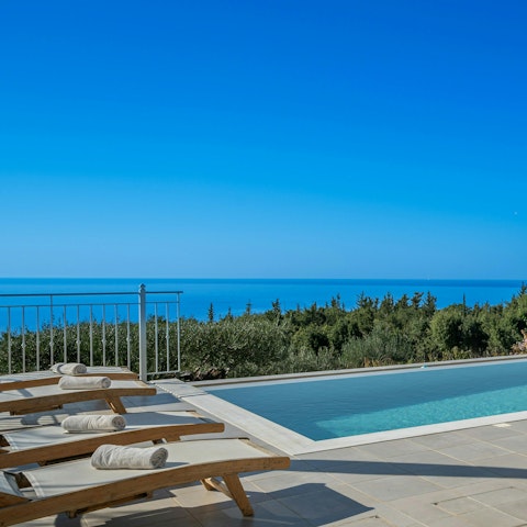 Enjoy long, lazy days lying by the swimming pool
