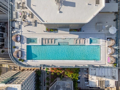 Swim laps above the Miami skyline at sunrise