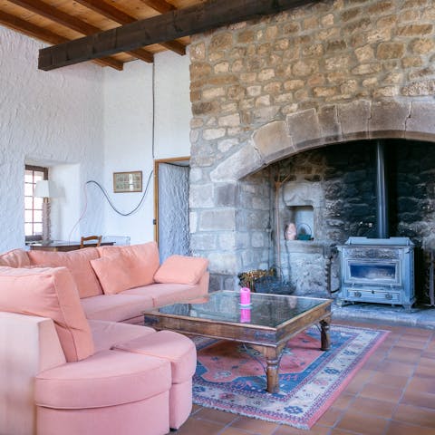 Gather around the wood burner fireplace on chilly winter evenings with a glass of wine