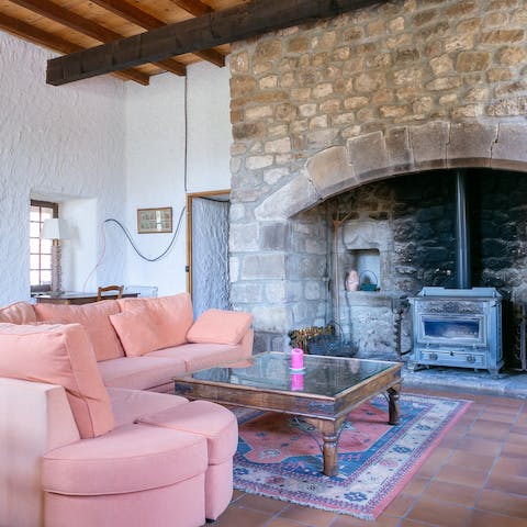 Gather around the wood burner fireplace on chilly winter evenings with a glass of wine