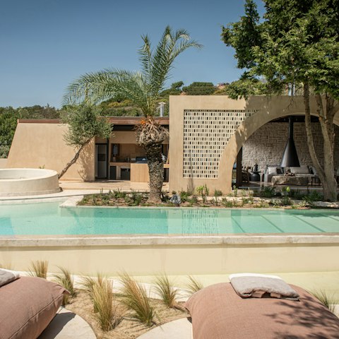 Lounge under the palm trees by the private pool